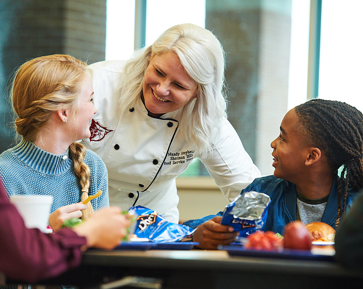 school children with chef in cafe